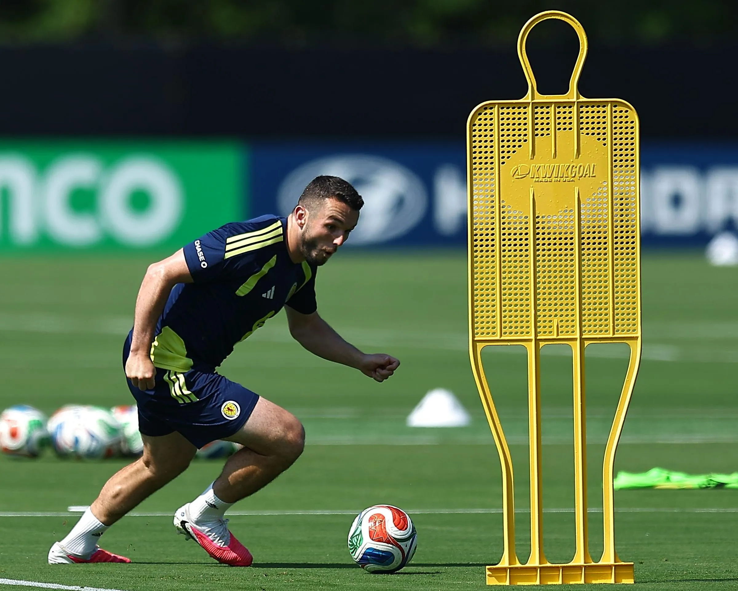John McGinn goes past a wall dummy during a Scotland training session.