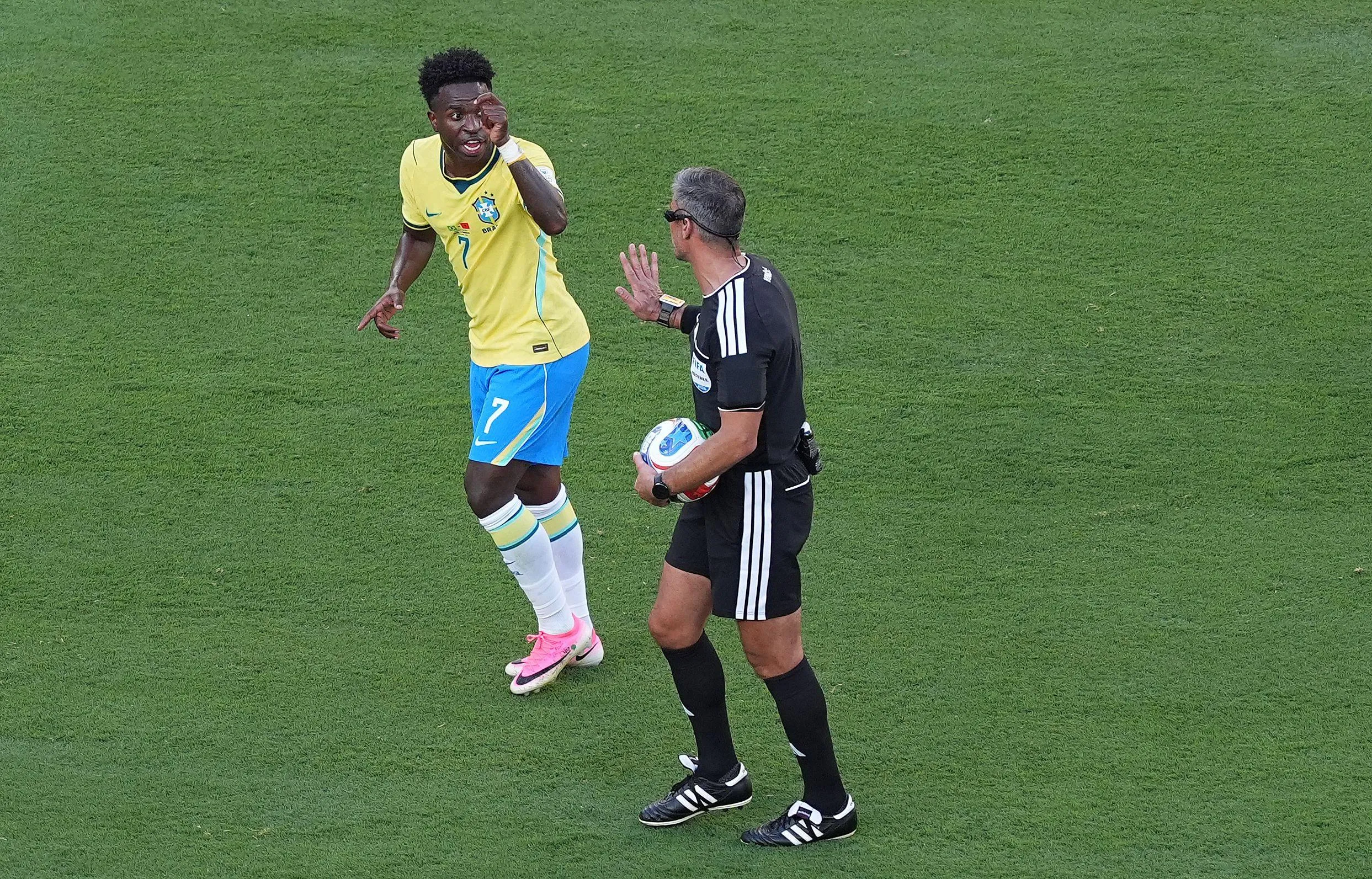 Vinícius Júnior of Brazil questions referee Slavko Vincic as he asks for a card to be shown to a Morocco player