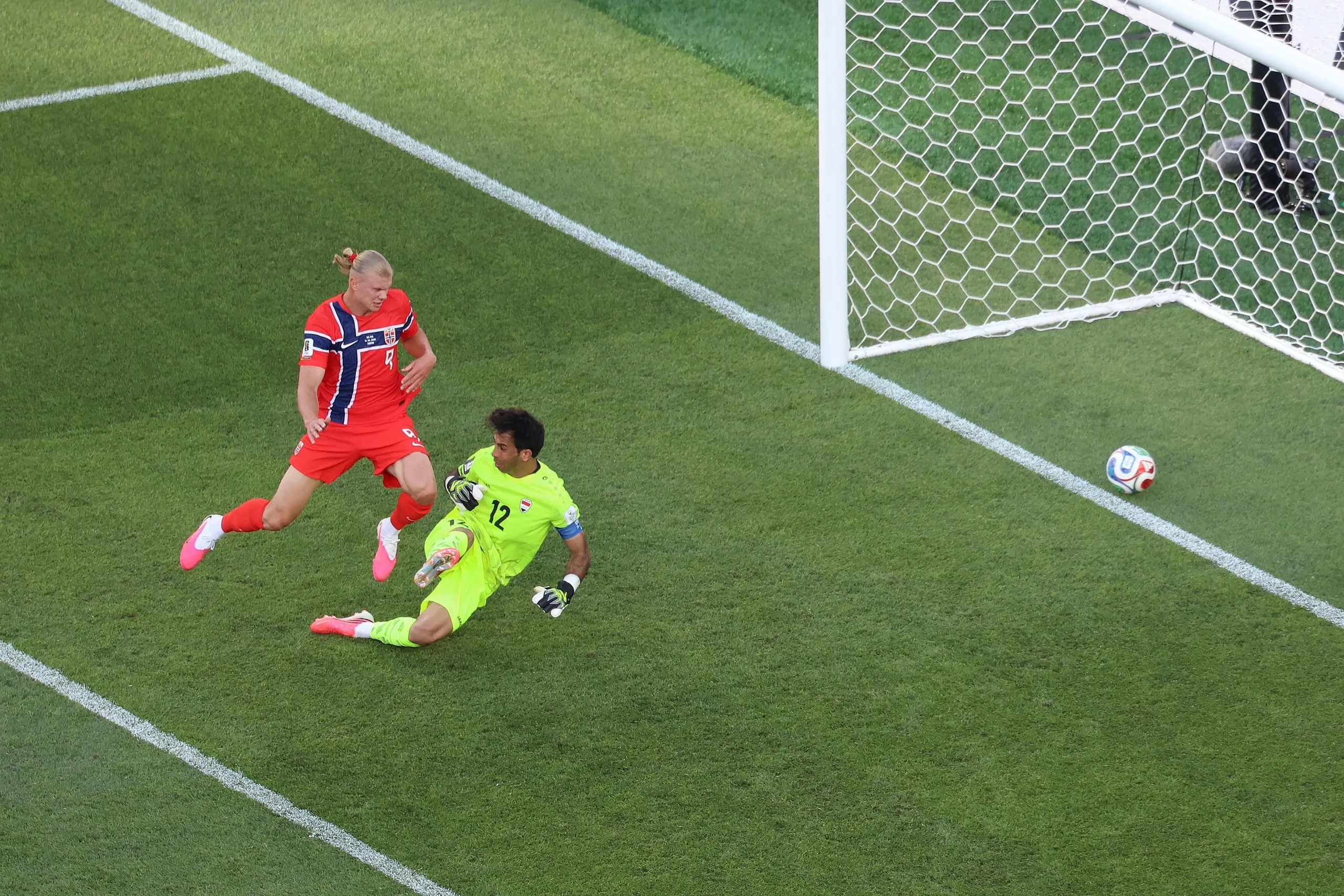 The ball crosses the line behind Jalal Hassan as Erling Haaland watches