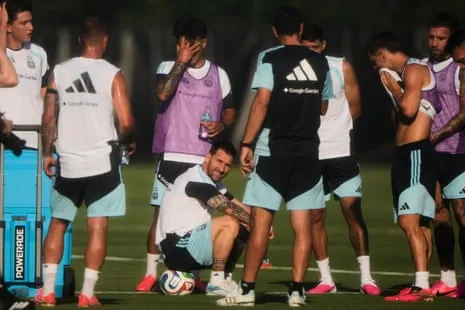 Lionel Messi takes a break with his Argentina teammates during a training session