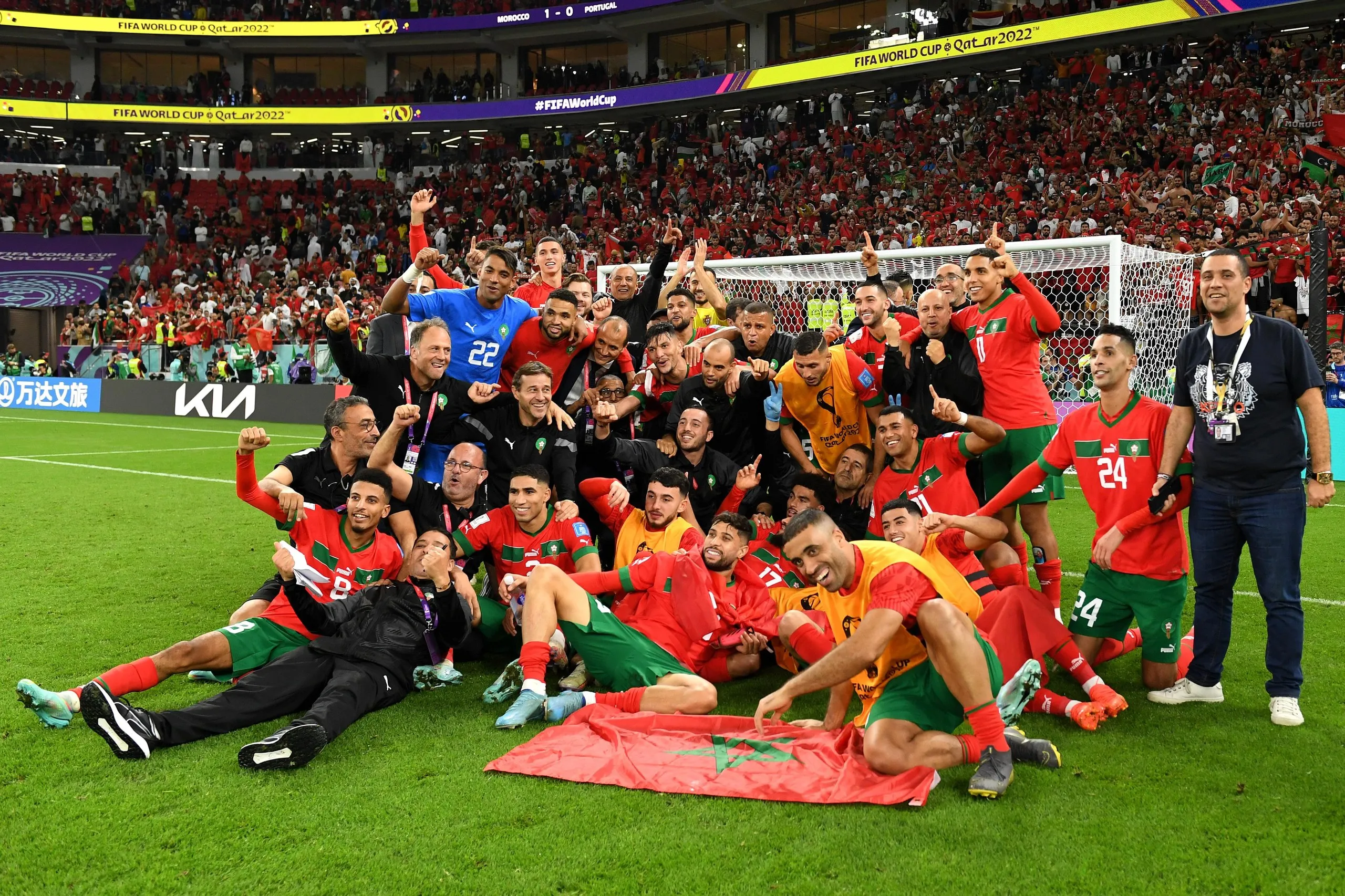Morocco players pose for a photo after beating Portugal in the quarter-finals in 2022