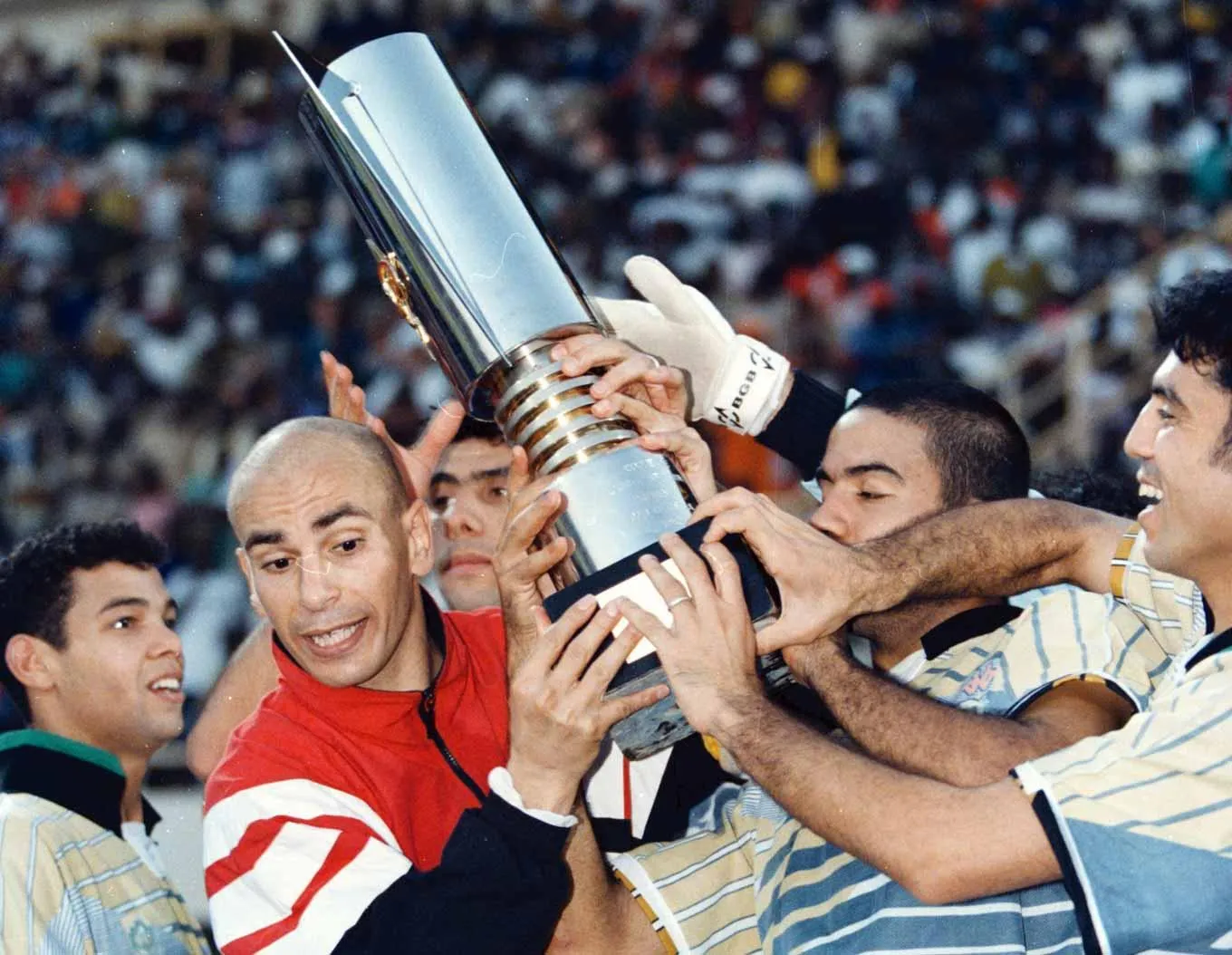The Egyptian team help captain Hassan Hossam (second left) hold up the Africa Cup of Nations trophy after defeating defending champions South Africa 2-0 in 1998.