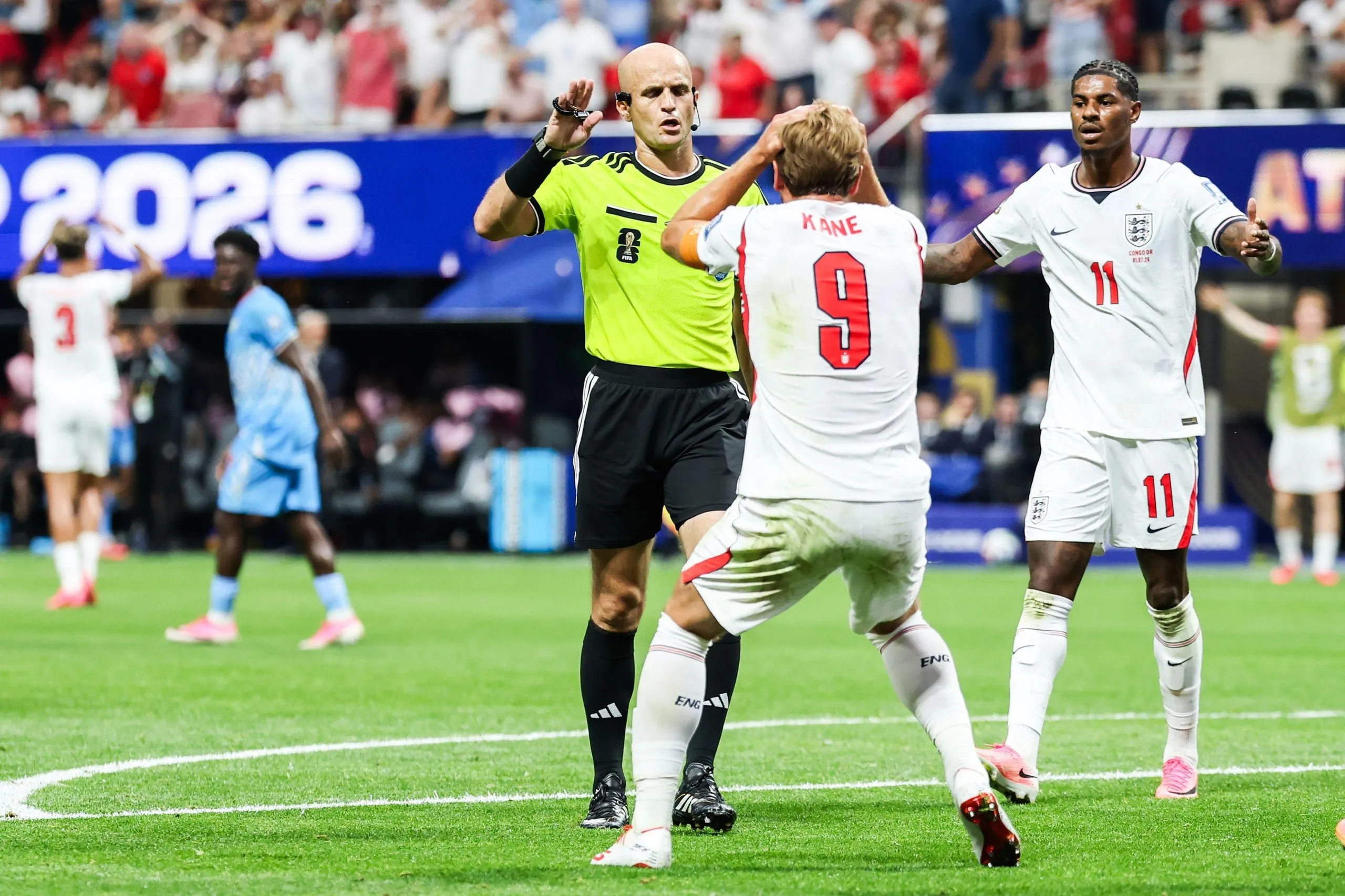 The referee Adham Makhadmeh tells Harry Kane he is not awarding a penalty after his collision with the DRC goalkeeper