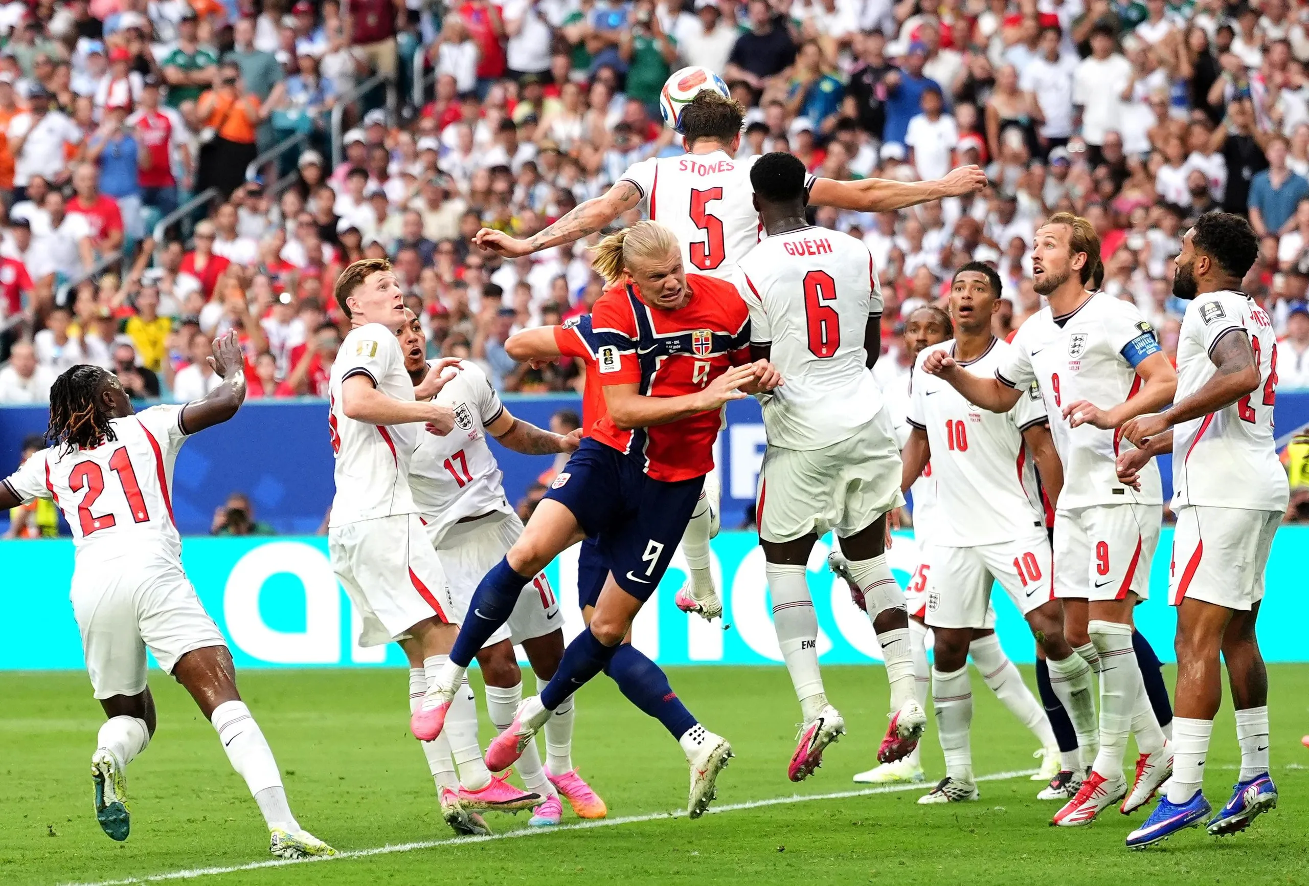 Norway’s Erling Haaland collides with England’s John Stones and Marc Guéhi.