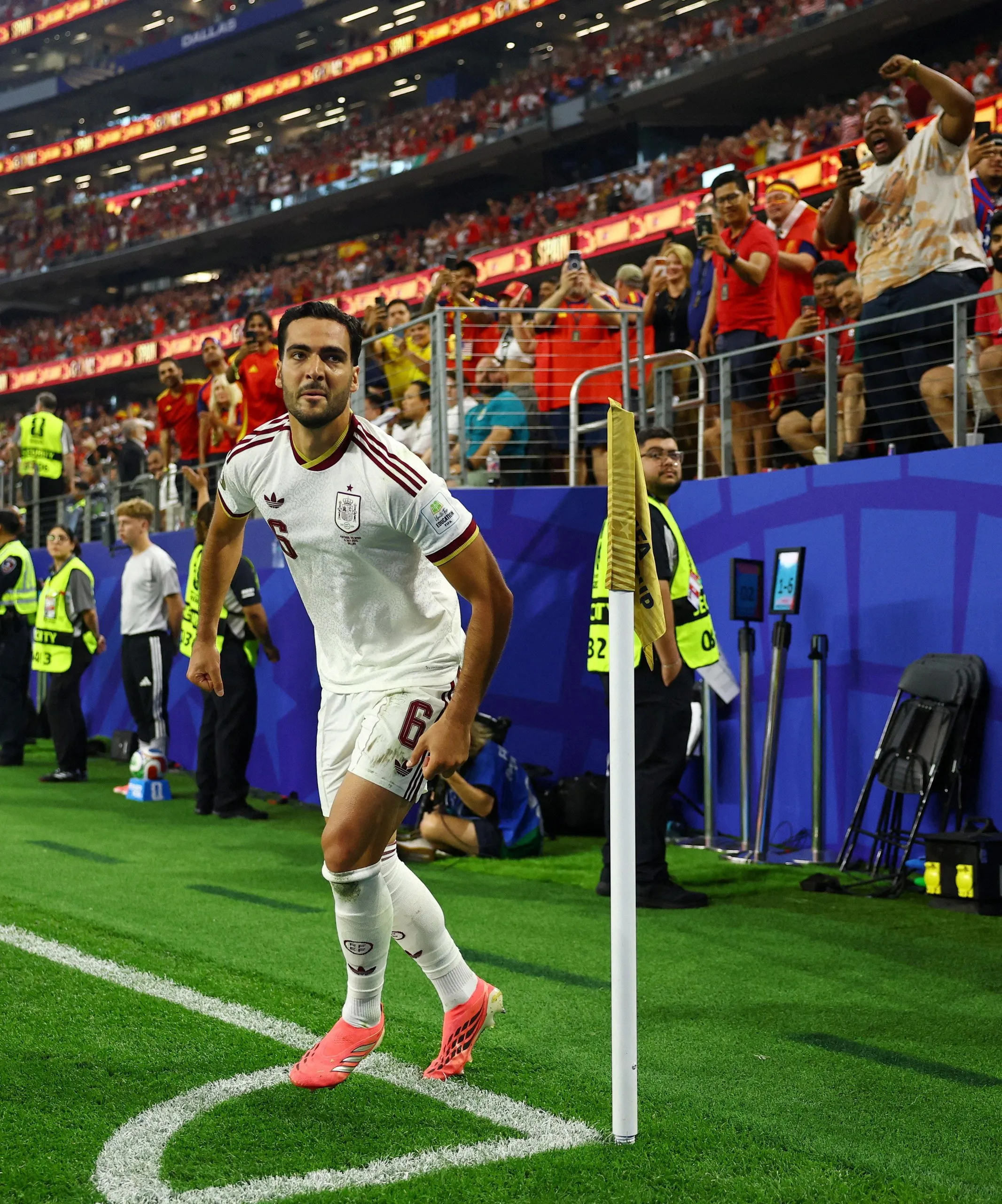 Merino circles the corner flag after securing victory for Spain