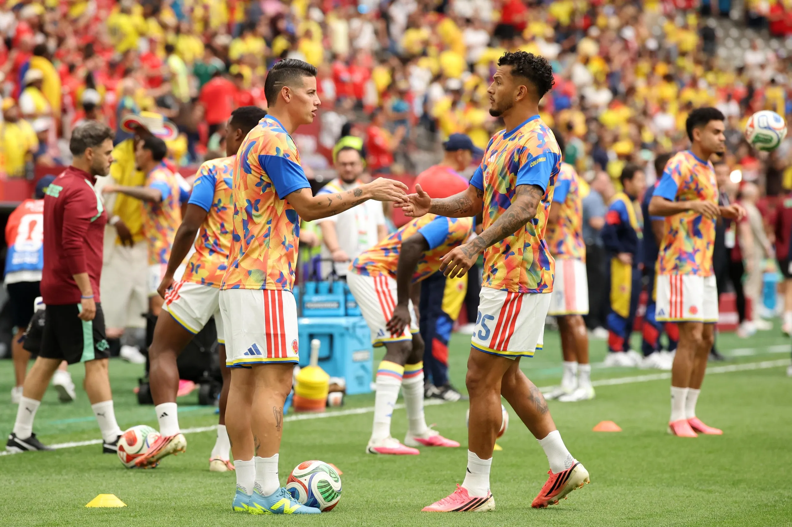 James Rodriguez and Luis Suarez warm up