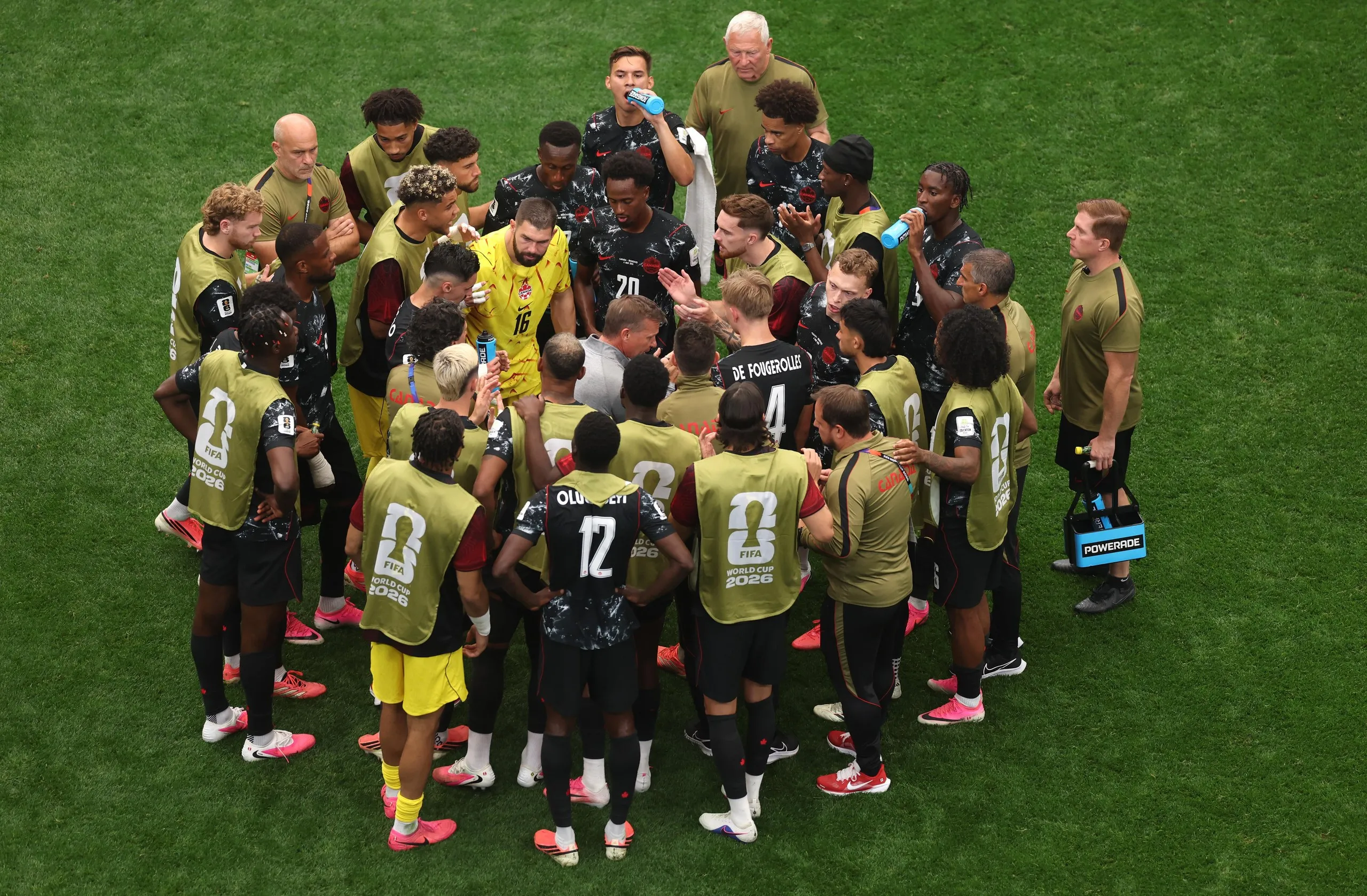 Canada head coach Jesse Marsch talks to his players during a hydration break