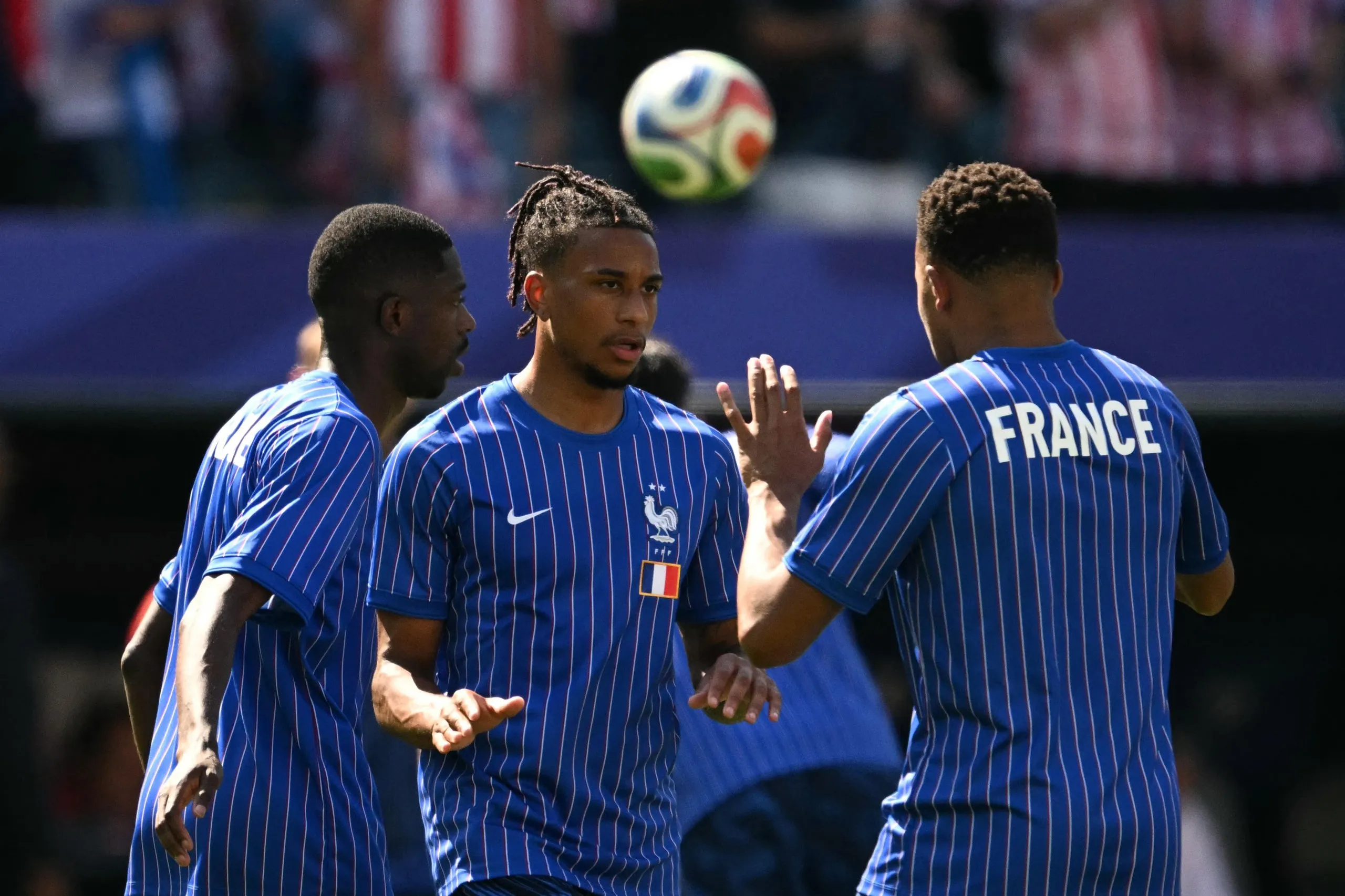 Michael Olise warms up with Ousmane Dembele and Kylian Mbappe